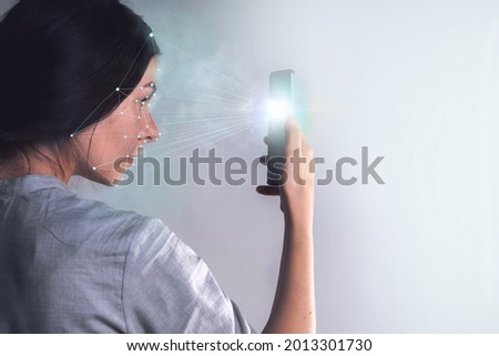 Smart technologies in your smartphone, identification of the phone owner's face ,identity verification to protect personal data. Face recognition technology Royalty-Free Stock Photo #2013301730