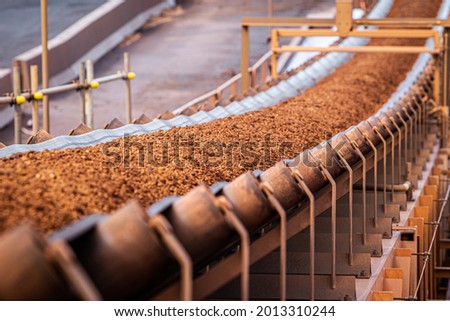 conveyor belt moving iron ore Royalty-Free Stock Photo #2013310244