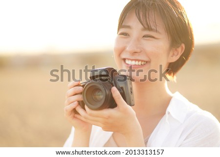 Image of a woman taking a picture 
