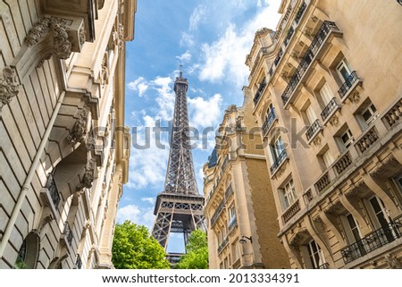 Paris, beautiful Haussmann facades in a luxury area of the capital, with the Eiffel Tower in background