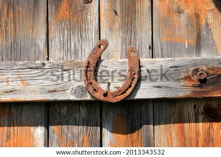 Steel horseshoe on wooden plank background. Old Rusty horseshoes on a wooden wall
