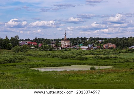 Rural summer landscape with church and swamp
