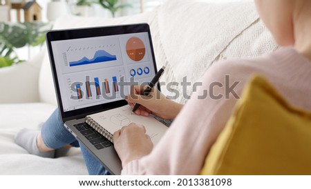Young asian woman employee busy work online on laptop computer screen at home freelance sale data analytic, data driven marketing science scientist engineer for business intelligence reskill upskill.