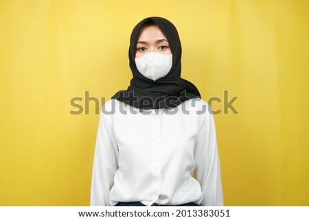 Muslim women wearing white masks, anti corona virus movement, anti covid-19 movement, health movement using masks, isolated on yellow background