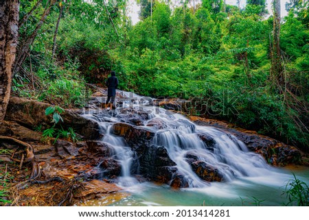 Waterfall in tropical rainforest in Malaysia. Slow shutter photography technic 