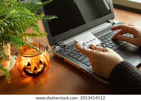 Halloween online shopping, sales and discounts promotions during the spooky day. Online shopping at home in october. Black fridays sale.