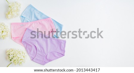 Flat lay set of women panties of different colors on a white background. Top view advertising and shopping concept Royalty-Free Stock Photo #2013443417