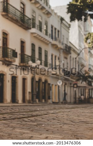 cobblestone street with old houses in the background