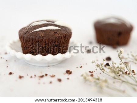 tasty chocolate cupcakes on white tablecloth
