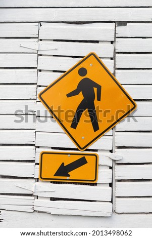 Yellow and black pedestrian warning sign