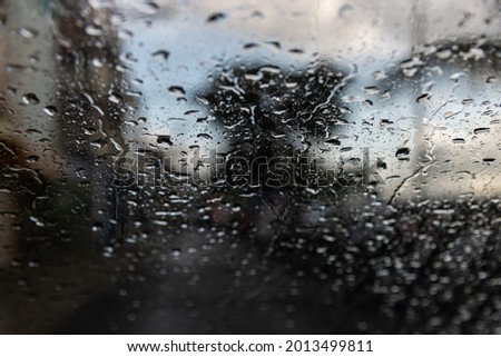 Salvador, Bahia, Brazil - April 04, 2021: rain drops on car window. The image becomes blurry due to the movement of water falling on the glass.