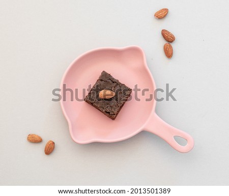 Piece of brownie with almonds