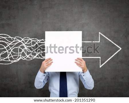 Businessman is holding an empty banner, there is a wall sketch of arrow sign which indicates the right direction of the development. Dark background. Royalty-Free Stock Photo #201351290