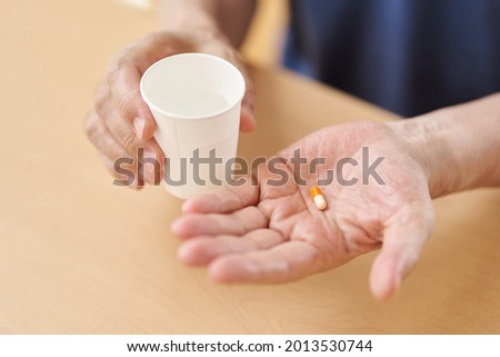Hands of elderly people who drink medicine Royalty-Free Stock Photo #2013530744