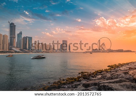 A delightful and colorful sunset over Blue waters Island with the famous Dubai Eye Ferris wheel. Panoramic view of the city in UAE Royalty-Free Stock Photo #2013572765