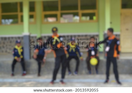 Blur photo with schoolchildren playing outside school
