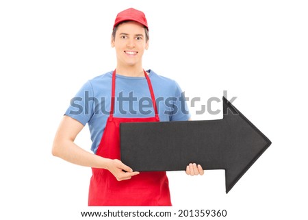 Man in apron holding a big black arrow pointing right isolated on white background