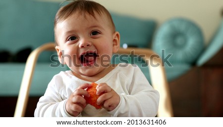 Adorable baby toddler face reaction, infant boy laughing and smiling Royalty-Free Stock Photo #2013631406