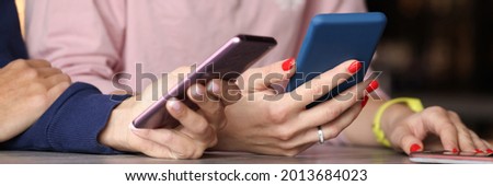 Two people are holding smartphones in their hands closeup