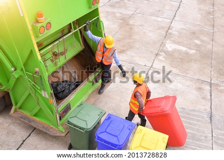 Workers collect garbage with Garbage collection truck,Garbage collection workers in residential area Royalty-Free Stock Photo #2013728828