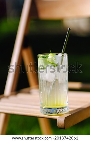 Alcoholic and non-alcoholic summer drinks with ice cubes of lemon, lime, fruits and mint. Summer holiday tropical concept.