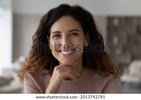 Close up profile picture of smiling millennial Hispanic woman look at camera feel optimistic confident. Portrait of happy young Latino female client or customer posing. Diversity, laughter concept.