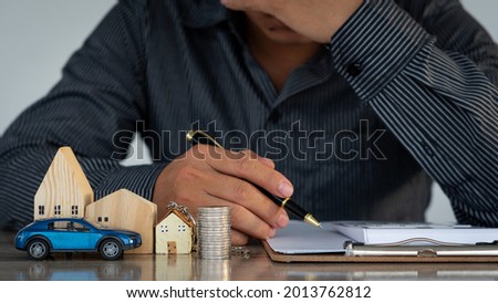Young man is worried about car loan, home loan and calculate multiple pay per month financial accounting concept.