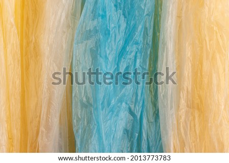 Used crumpled plastic bags. Full frame background. Top view. Royalty-Free Stock Photo #2013773783