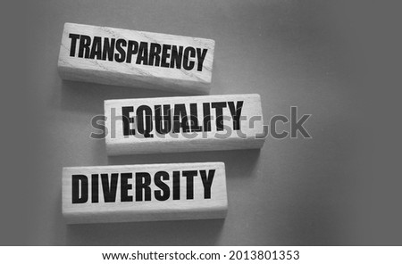 Transparency Equality diversity words on long wooden blocks on black background. Equality concept by gender, ethnicity and age.