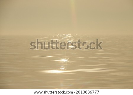 The sea in the fog. The line of the horizon, dissolving in the fog with blurred sun. Irish sea in fog. Foggy weather 