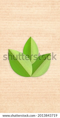 Paper cardboard background with green leaves  in paper cut style. Vertical banner with eco paper texture. Recycled carton material. Copy space for text. Mock up template