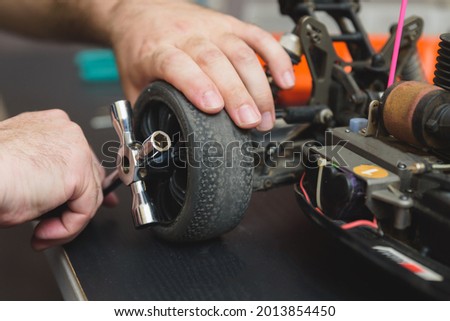 Young Caucasian male assembling toy RC car at home in the evening Royalty-Free Stock Photo #2013854450