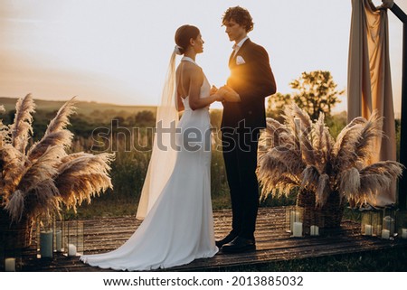 Bride and groom on their wedding ceremony Royalty-Free Stock Photo #2013885032