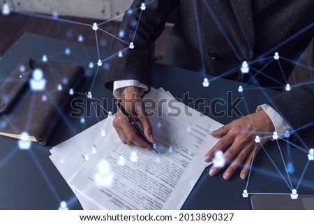 African American businesswoman signing the contract to boost her career and gain new opportunities in personal growth. Hiring new talented crew. Social media hologram icons. Women in business concept