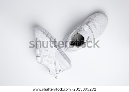 useful sports habits and orthopedic shoes for children shoeing isolated on a white background.