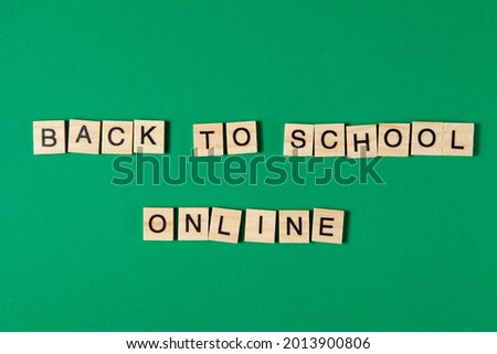 Back to School Offline Text by wooden letters on a green background. Distance education due to pandemic-wide quarantine. Distance learning concept.