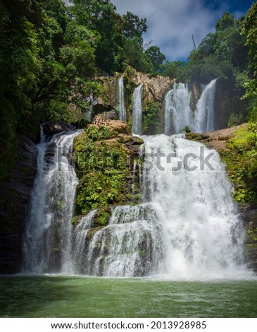 A front picture of stunning tropical, white and wide Nauyaca Waterfalls in Costa Rica.