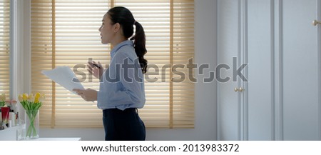 Young female leader, asia people lady or mba student happy standing smile look at in front of mirror pep talk for sale pitch hold paper document script public speak skill for job career self improve. Royalty-Free Stock Photo #2013983372