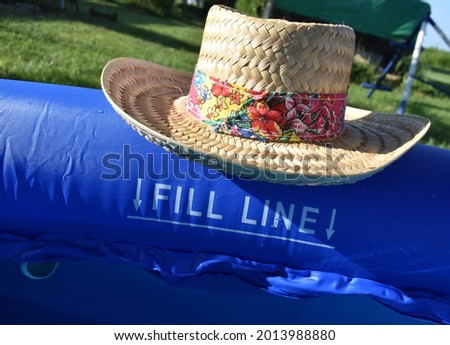 Straw hat by a swimming pool