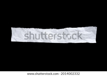 Recycled paper craft stick on a black background. white paper torn or ripped pieces of paper isolated on black background with clipping path.