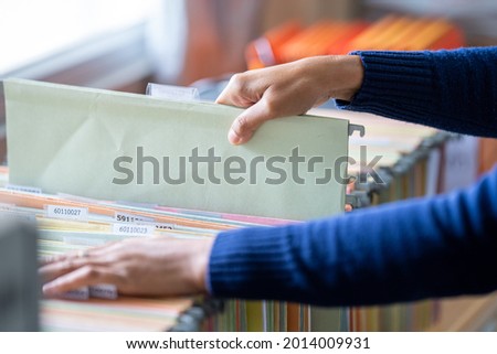 business woman hands searching information in Stack of papers files on work in office,