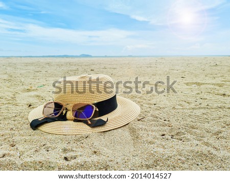 Hats and glasses placed by the sea concept of nature surfing seaside relaxation . Copy space.