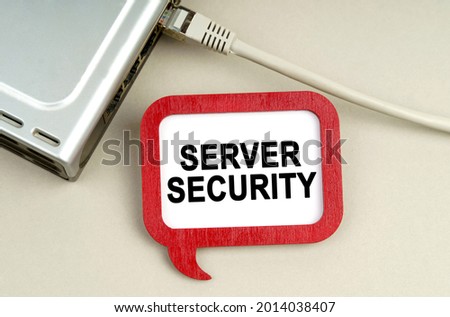 Internet and security concept. There is a router connected to the network on the table, next to a sign that says - Server security