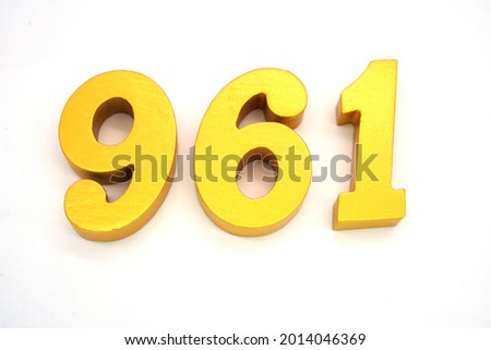   Arabic numerals 961 gold on white background                                