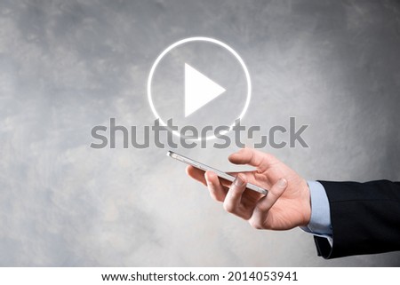 Businessman pressing, hold play button sign to start or initiate projects.Video Play Presentation. Idea for business, technology.media player button. Play icon.Go.