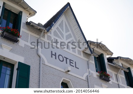 Hotel sign text wall city building facade in french tourist town