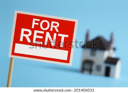 Real estate agent for rent sign with house in background