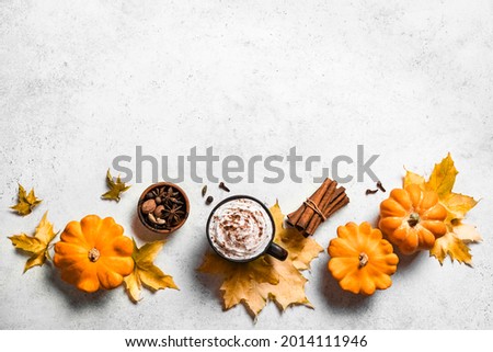 Autumn composition with pumpkins, maple leaves and pumpkin latte coffee on white stone, top view, copy space. Seasonal fall, Thanksgiving background  banner.