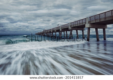 Juno beach twilight tide with dramatic sky and blue waters at Jupiter, Florida, United States