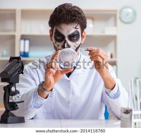 Scary monster doctor working in lab Royalty-Free Stock Photo #2014118780